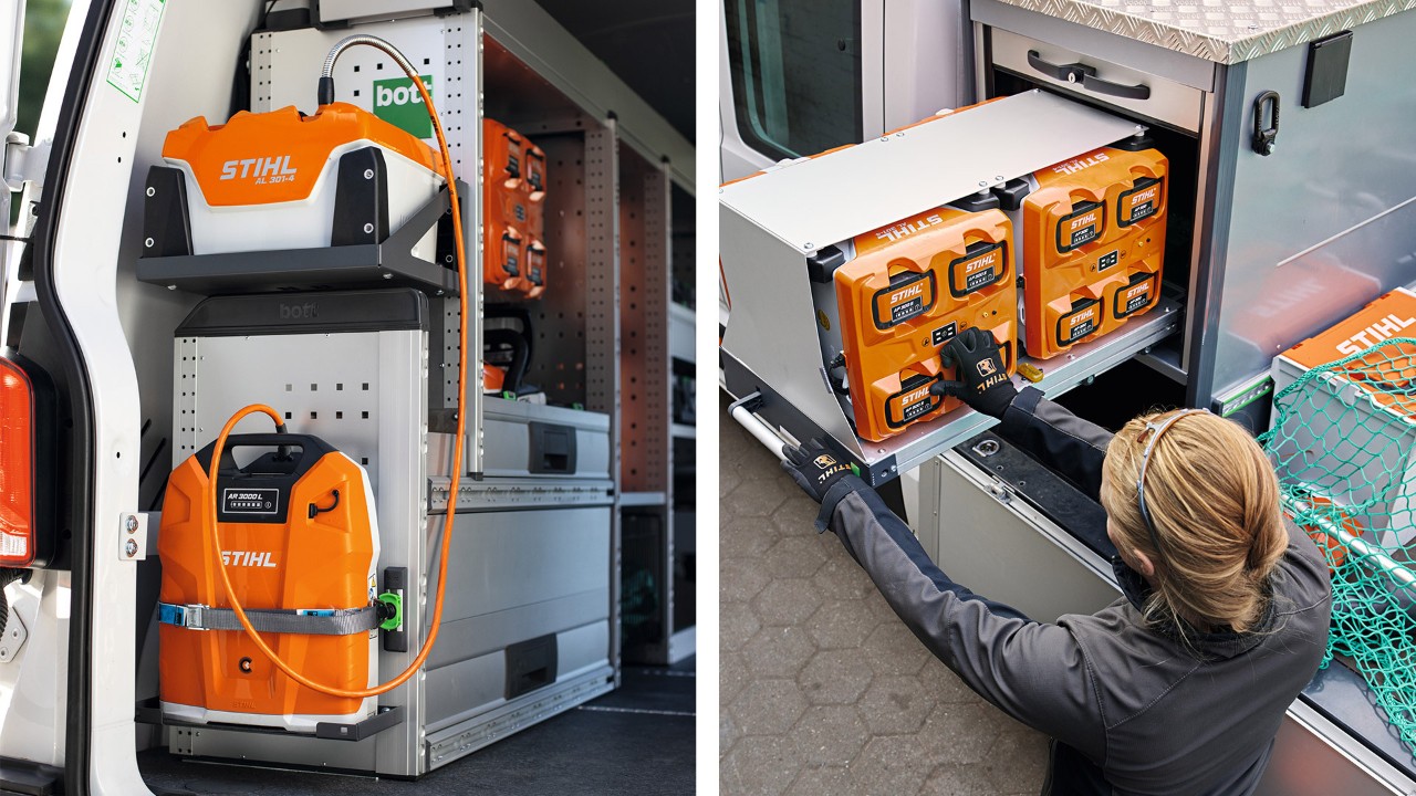 Femme de profil à côté d’un véhicule avec plateau de chargement en train de manipuler les batteries dans le bottTainer